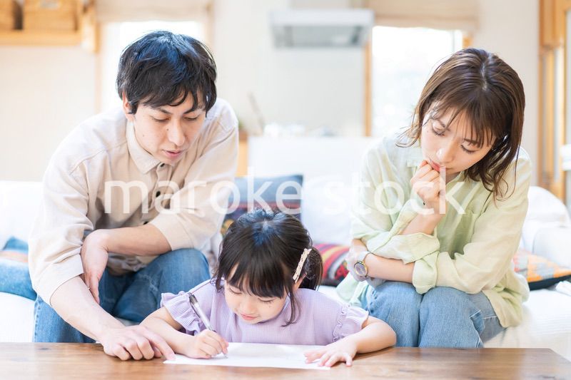 家でお勉強をする女の子と両親