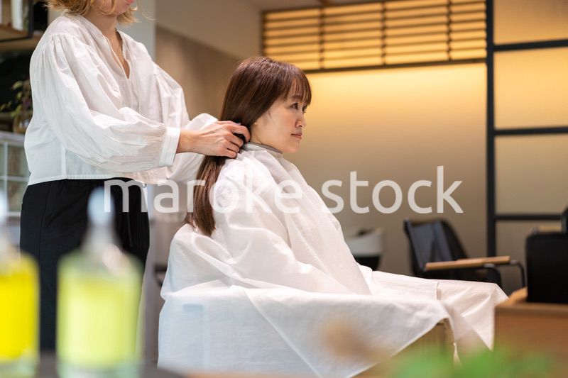 女性のヘアカットをする美容師
