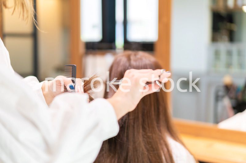 女性のヘアカットをする美容師