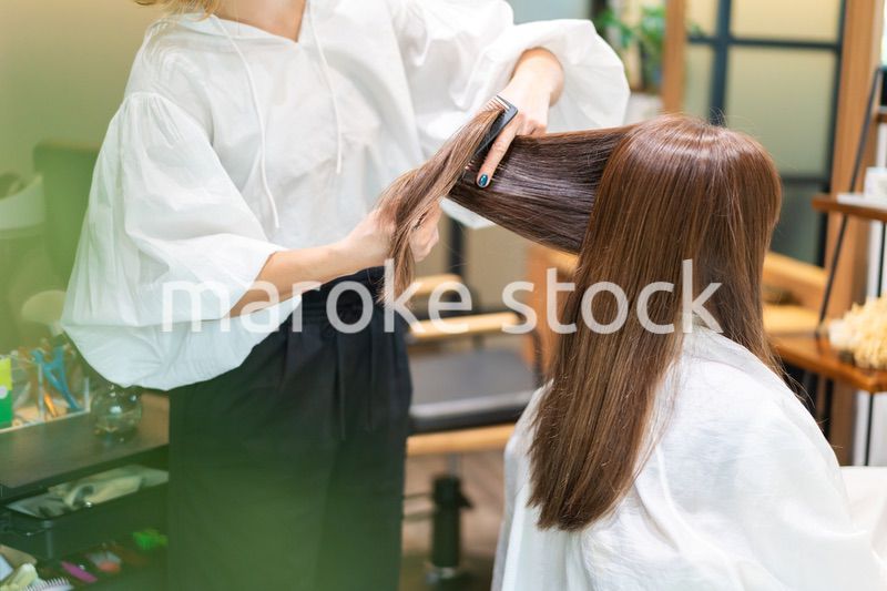 女性のヘアカットをする美容師