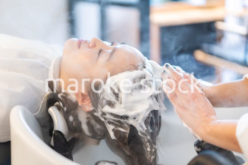 ヘアサロンでスチームトリートメントを受ける女性